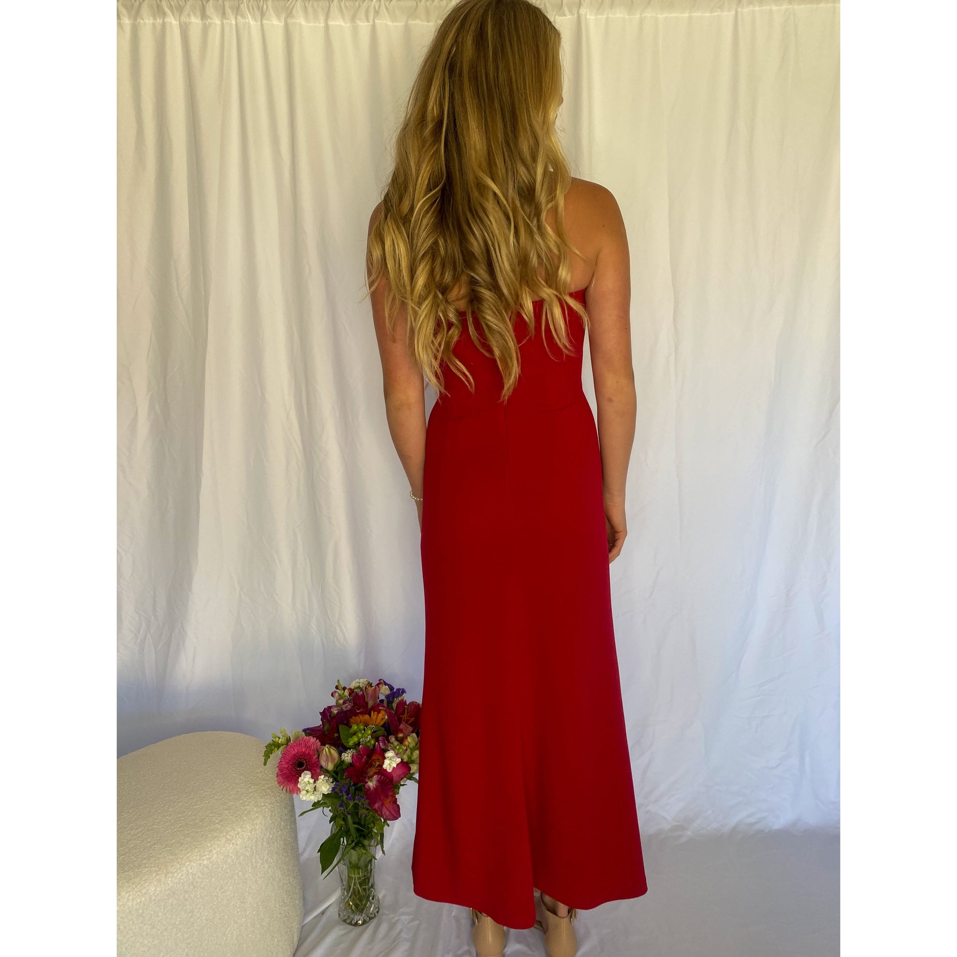 xRed strapless full length dress. Top bit of dress has boning like a corset an zip up back. Size XS best fitted to a 8 - small 10. Front on view of the back of the dress