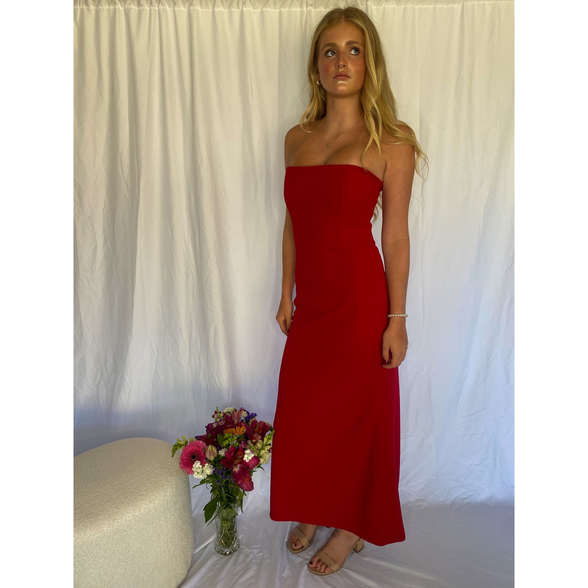 Red strapless full length dress. Top bit of dress has boning like a corset an zip up back. Size XS best fitted to a 8 - small 10. Standing up front/side view of dress