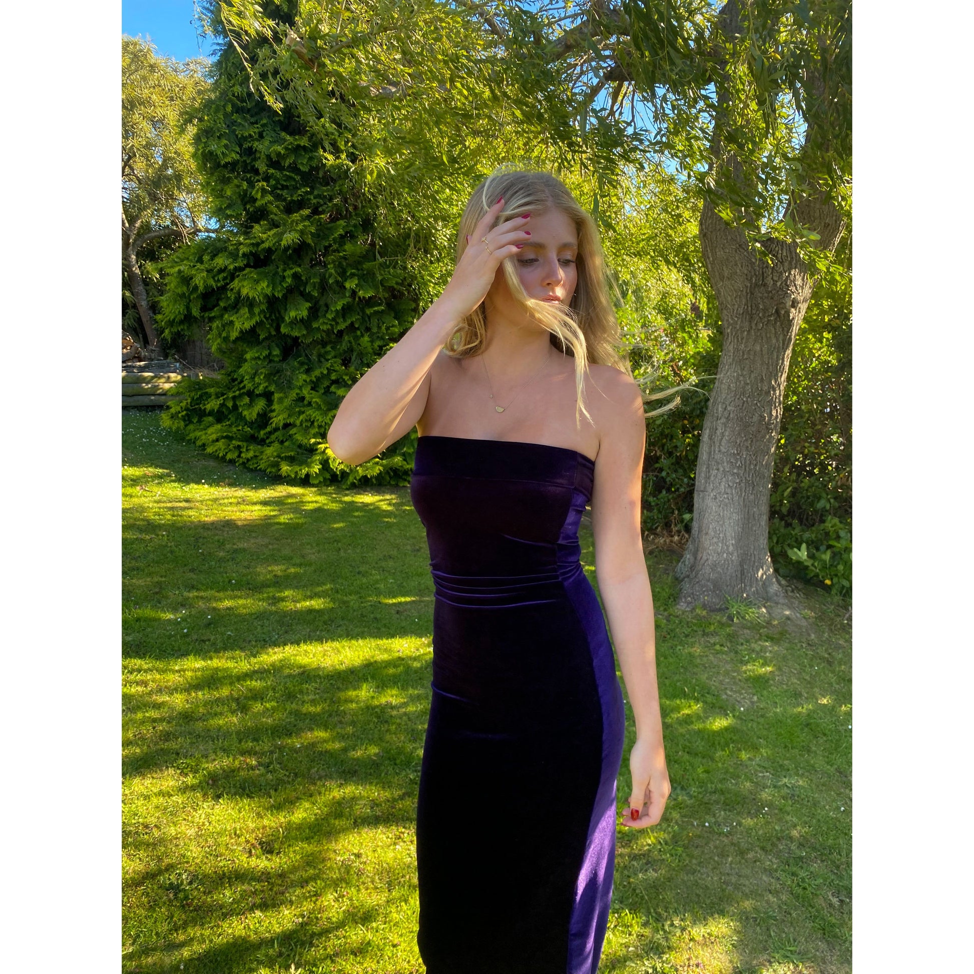 7th and York Strapless Midi Dress in Blackberry, Velvet Material - comes with optional sleeves. Perfect for a variety of formal events. Size 6 dress and Size S sleeves. Side on view of dress without the sleeves, image cuts off just below knee length