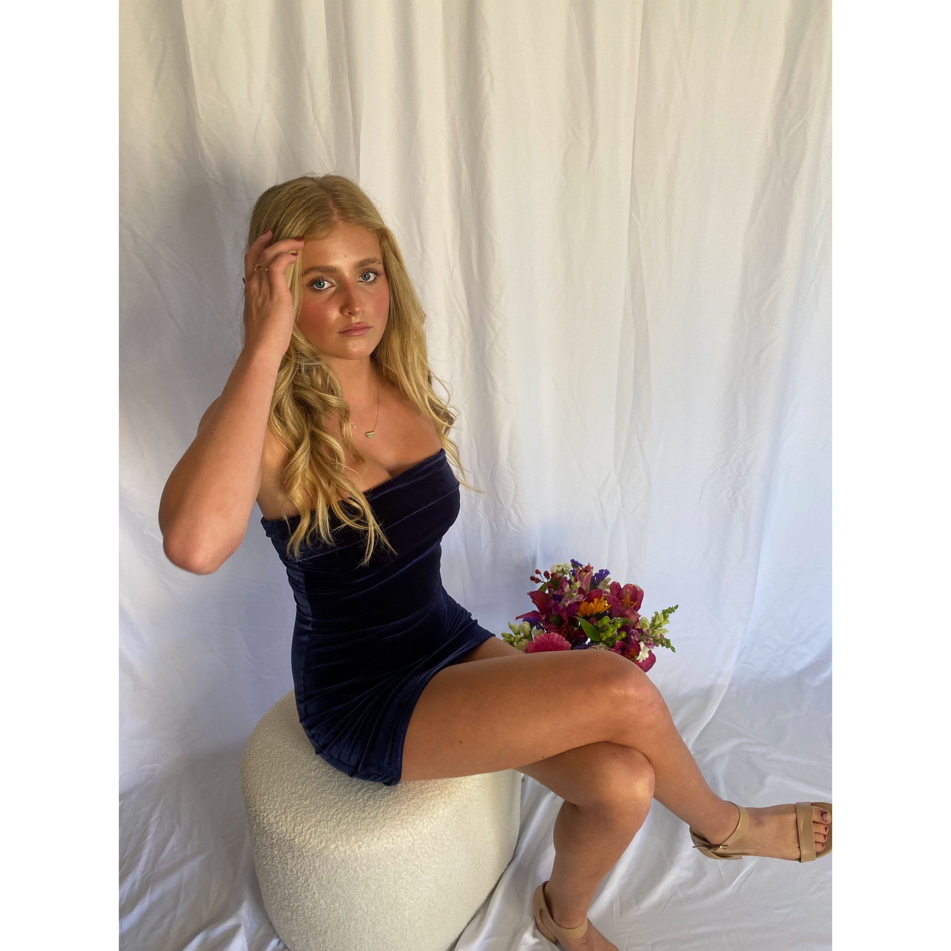 7th and York Strapless Mini Dress in Midnight (Navy), Velvet Material. Perfect for events like the races, birthdays etc. Size 8/S dress. Sitting on chair slightly above view of dress