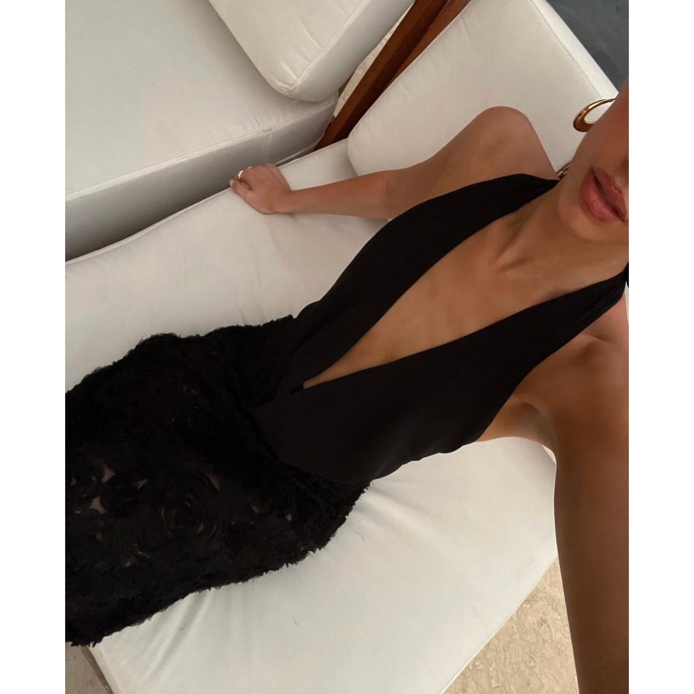 Arcina Ori Adriana Dress in Black, Size M. Low draping front that's is adjustable. Open back with one small strap to connect top area. Skirt flower patterned and is semi sheer.  Above view of dress while sitting down