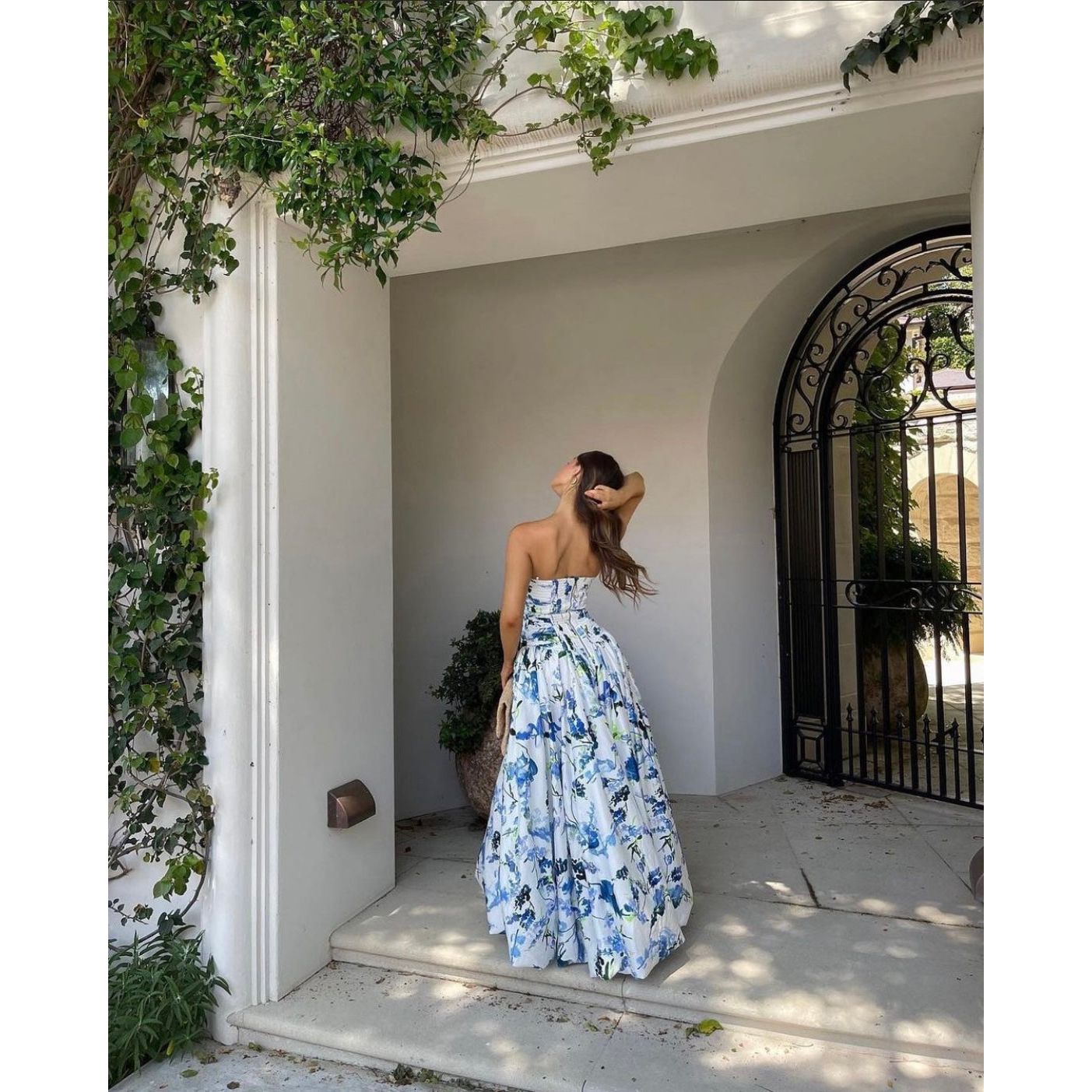 Aje Violet Bubblehem Maxi Dress in Blue Floral, Size 8. Zip up back. Side split on leg up to mid thigh. Tight fitting (with stretch) bust and torso and puffy bottom. Back view off the dress.