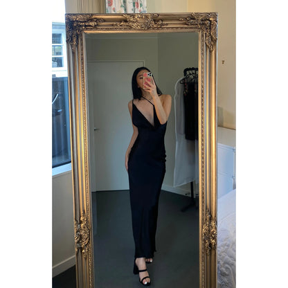 Johannah Cowl Midi in Black, Size 8. Featuring an asymmetrical design with a low cut bust area and low draping back with slight adjustability of strings tying at bottom of back area. Perfect for formal events. Front on view of dress over one shoulder