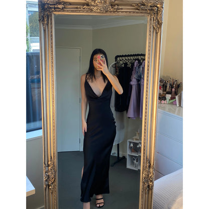 Johannah Cowl Midi in Black, Size 8. Featuring an asymmetrical design with a low cut bust area and low draping back with slight adjustability of strings tying at bottom of back area. Perfect for formal events. Front on view of dress over two shoulders