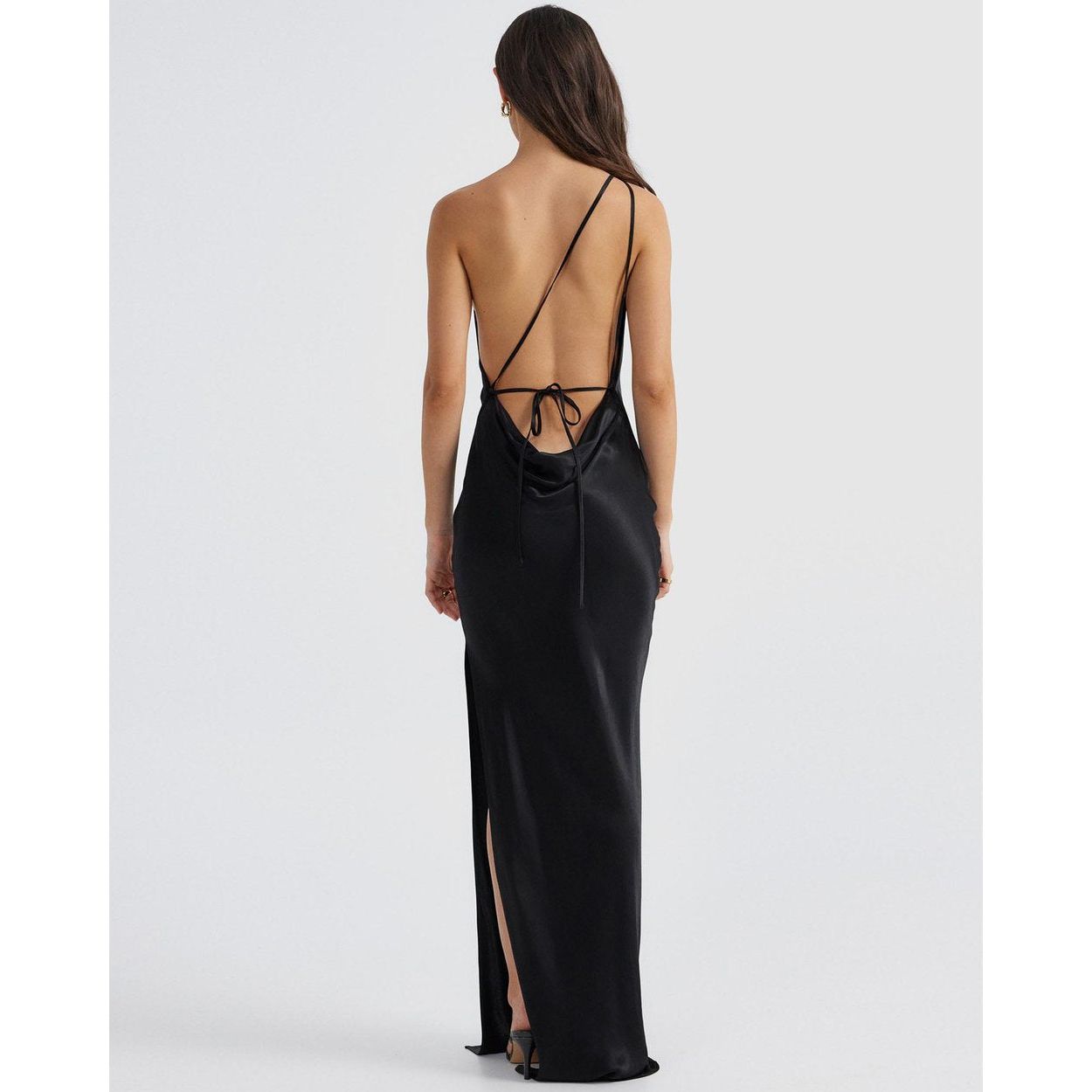 Johanna Cowl Midi in Black, Size 8. Featuring an asymmetrical design with a low cut bust area and low draping back with slight adjustability of strings tying at bottom of back area. Has a leg split that ends mid thigh. Perfect for formal events. View of back of dress.