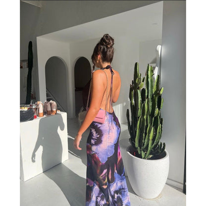 Rat and Boa Antonella Maxi, Size M. Viscose fabric printed with bold aspect florals and tie dye details. Featuring halter neck style with a plunging neckline and open back. This dress has a semi sheer effect. This is a long dress. Back side view of dress.