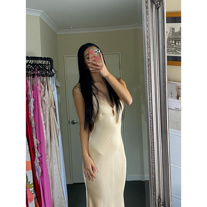 Bec and Bridge Cedar City in custom Peachy/Champagne Shade, Size 8. Open back with adjustable straps/back of bust area. Perfect for formal events. Made of viscose and ecovero. Up close view of dress.