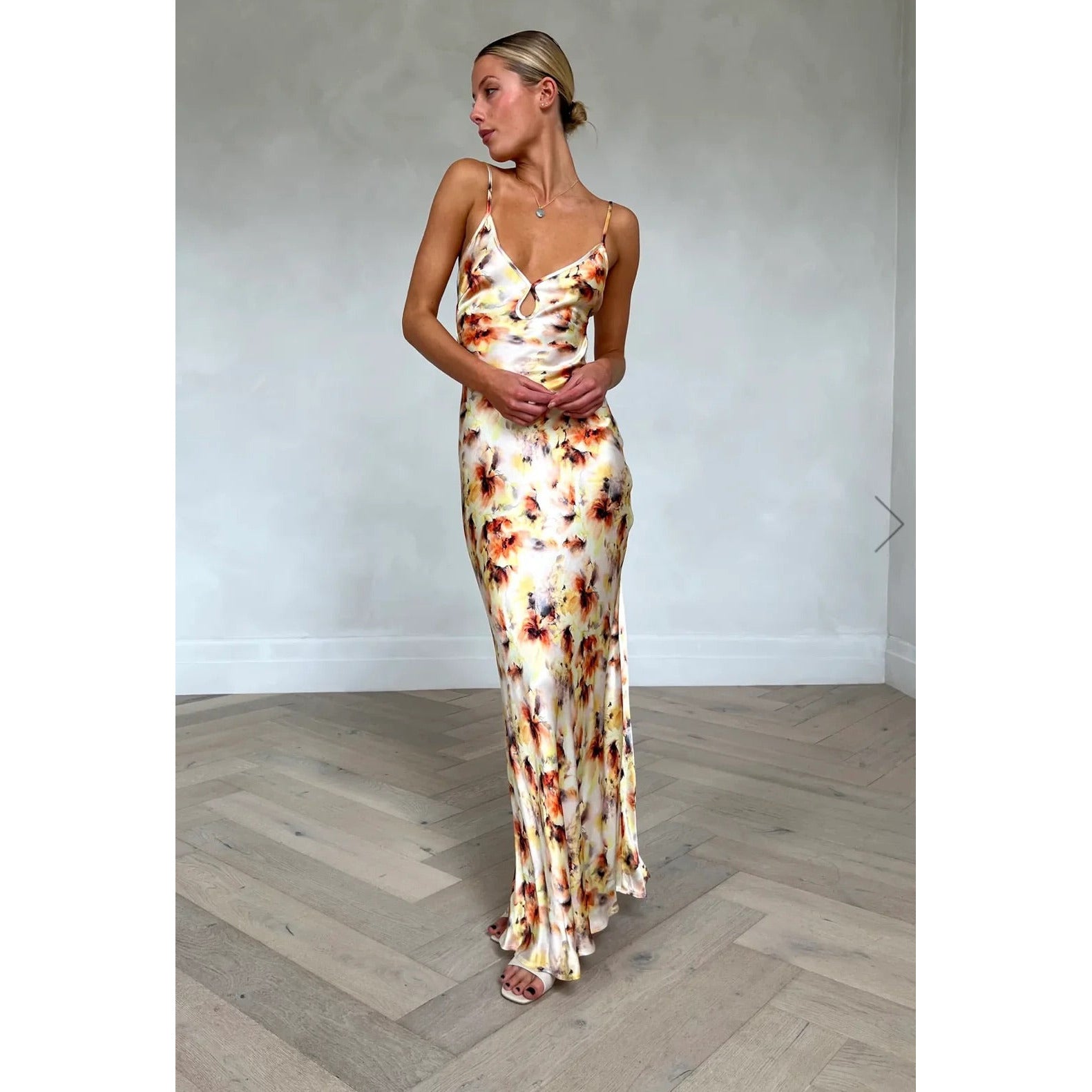 Bec and Bridge Cedar City in Sunset Floral Shade, Size 14. Open back with adjustable straps/back of bust area. Perfect for formal events. Made of viscose and ecovero. Front on full length view of dress.