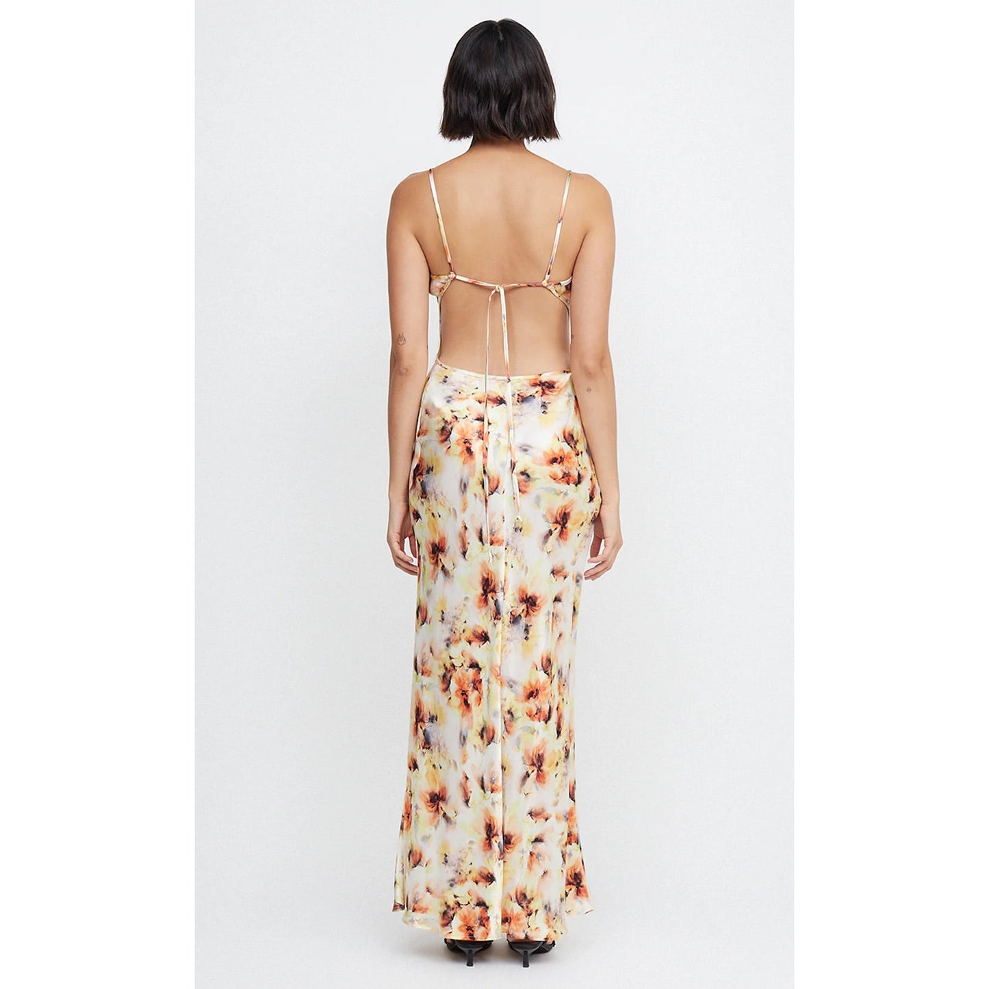 Bec and Bridge Cedar City in Sunset Floral Shade, Size 14. Open back with adjustable straps/back of bust area. Perfect for formal events. Made of viscose and ecovero. Back full length view of dress.