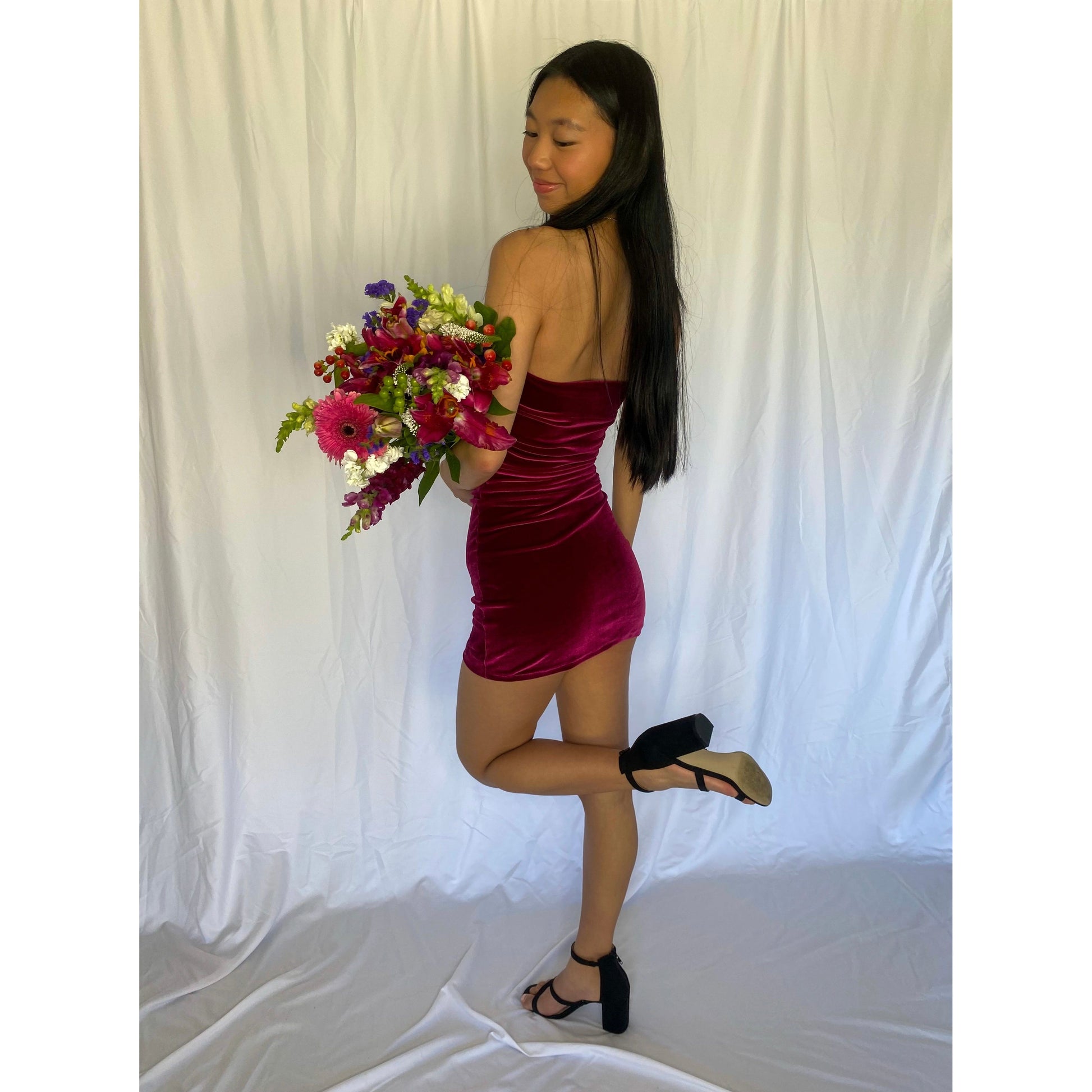 7th and York Strapless Mini Dress in Magenta, Velvet Material. Perfect for events like the races, birthdays etc. Size 6/XS dress. Standing back with slight side view of the dress