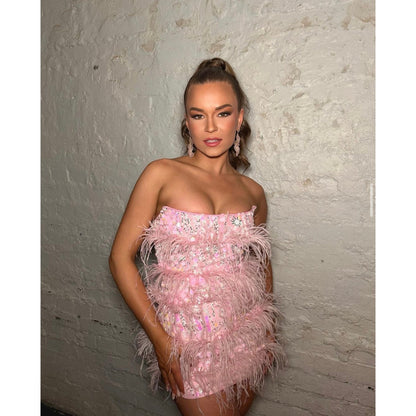 Eliya the Label Tiffany Mini in Pink, Size 8/S. Featuring feathers and sequins this is a dress to stand out in. Zip up back with corset boning in dress. Front on side view of dress