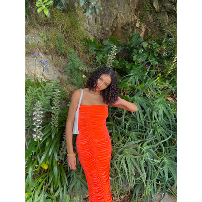 John Christopher Rogers Wiggle Dress in Orange. Best fits a Size 8. Rich velvet material this is a dress to standout in with it's almost fluorescent shade. Strapless design with zip up back. Perfect for formal events where you want to stand out. Front on view of dress.