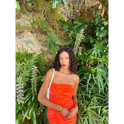 John Christopher Rogers Wiggle Dress in Orange. Best fits a Size 8. Rich velvet material this is a dress to standout in with it's almost fluorescent shade. Strapless design with zip up back. Perfect for formal events where you want to stand out. Front on up close view of dress.