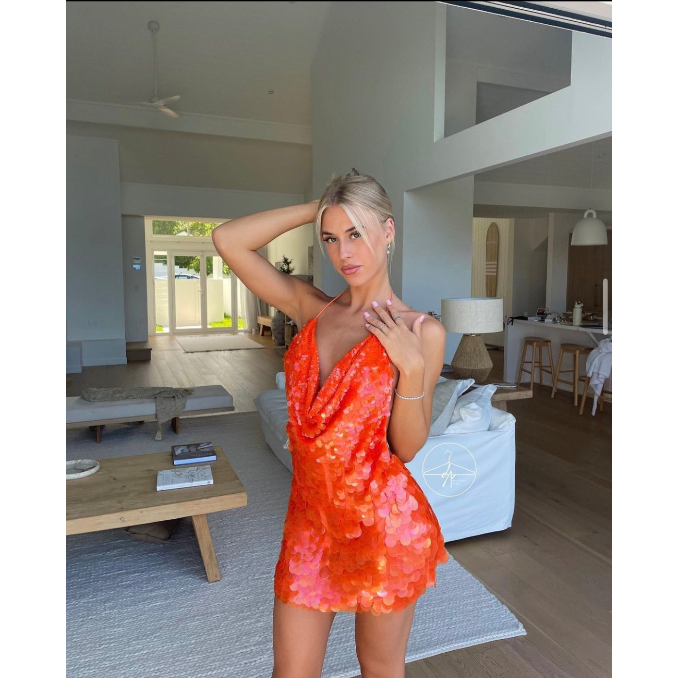 Rat and Boa Malika Mini in Orange Sequin, Size S. Featuring a big sequin design with an adjustable plunging necking and barely there ties with an open back. This is the perfect dress to stand out at an event. Front on side view of dress.