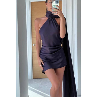 House of CB Aida Mini in Dark Purple, Size S. Asymmetrical bottom of dress with long neck piece that drapes down. Perfect for formal events where you want to wear a mini. Straps at back of dress that are removable. Front view of dress.