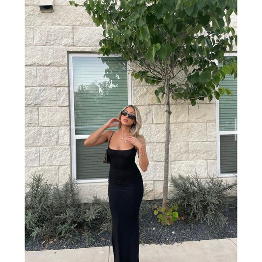 SKIMS Long Slip Dress in Onyx, Size XS and M. Featuring a body hugging fit, straight neck and adjustable spaghetti straps. Can be dressed up or down. Front on view of dress.