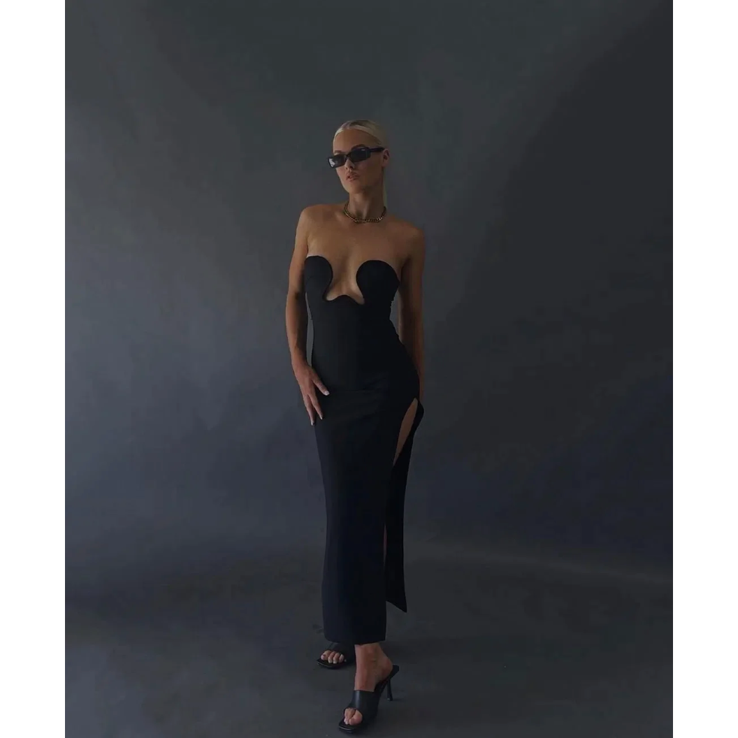 Morocco Maxi Dress in Black, Size XS and L. Featuring a unique strapless design with a zip up back and cut out area in middle of bust. This is a tight fitting dress. Split up side of dress ending mid thigh to make walking easier. This dress is best for formal events. Front on view of dress