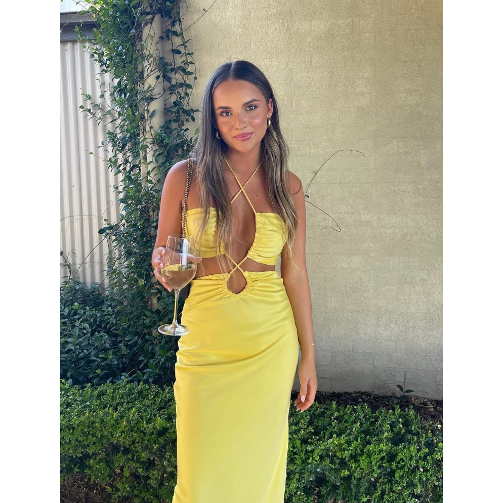 Jagger and Stone Ruby Maxi in Lemon, Size 6, 8 and 12. Featuring a unique design of intersecting straps on the torso area where the skirt and bust connect and again above the bust piece. Perfect for formals, races, birthdays etc. Front on view of dress