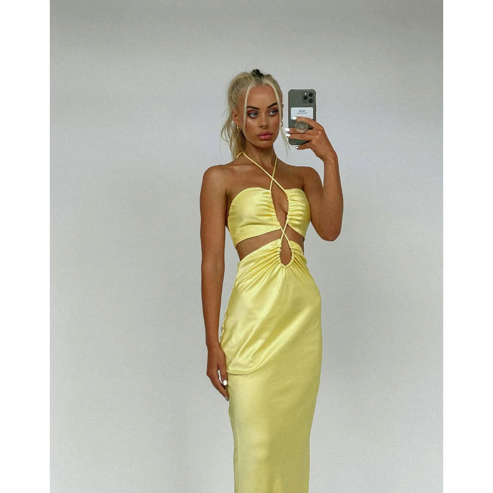 Jagger and Stone Ruby Maxi in Lemon, Size 6, 8 and 12. Featuring a unique design of intersecting straps on the torso area where the skirt and bust connect and again above the bust piece. Perfect for formals, races, birthdays etc. Front on slightly side view of dress