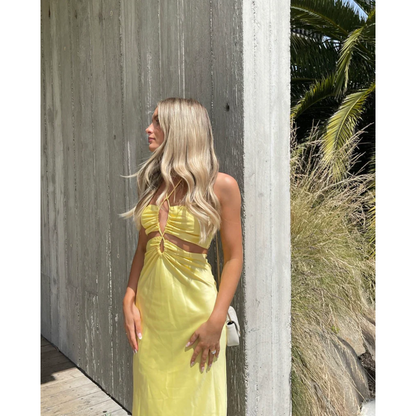 Jagger and Stone Ruby Maxi in Lemon, Size 6, 8 and 12. Featuring a unique design of intersecting straps on the torso area where the skirt and bust connect and again above the bust piece. Perfect for formals, races, birthdays etc. Front on side view of dress