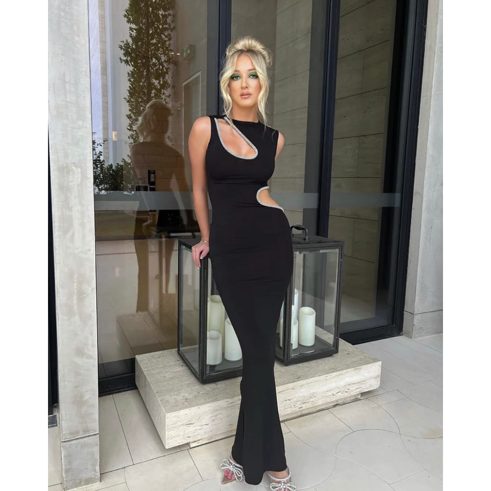 Ivona Skelo Vivia Dress in Black with Crystal Cut Outs, Size 8/S. Featuring two cut outs one at the waist and one at opposite shoulder the edge of both cut outs is covered with crystals. Perfect for formal events. Front of full length view of dress.