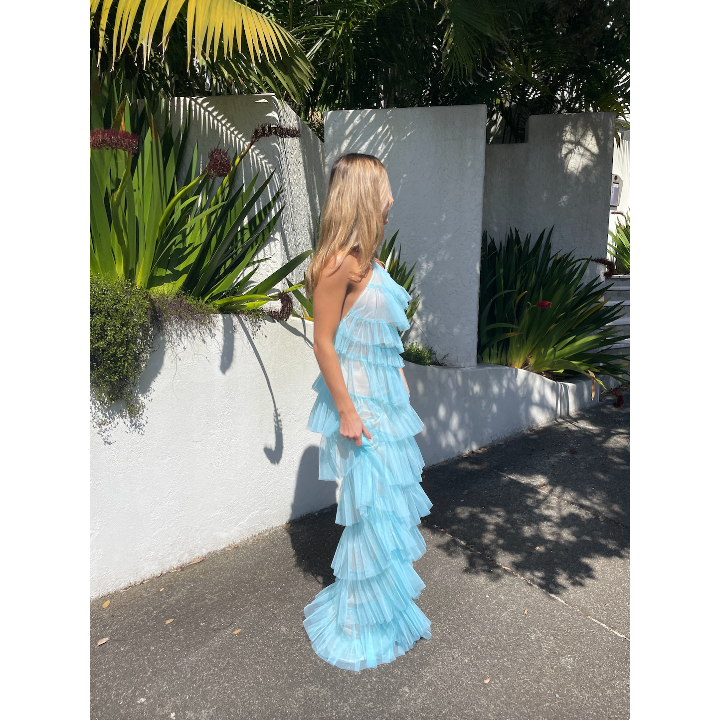 The Bar Henri Gown in Blue, Size US4 (AU8). Featuring Layered tulle fabric with a halter neck tie, side zip closure and side split, along with a low back. Semi Sheer but comes with a nude mini skirt that can be worn under. Perfect for formal events. Front side full length view.